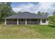 Rear exterior view of the home featuring a screened-in lanai, perfect for enjoying the outdoors bug-free at 29152 David Ct, Tavares, FL 32778