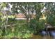 Inviting single-story home with lush landscaping, mature trees, and a charming dock on the waterfront at 29152 David Ct, Tavares, FL 32778