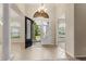 Bright foyer with tile flooring, a grand chandelier, and a view of the front yard at 29152 David Ct, Tavares, FL 32778