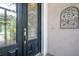 Elegant front door featuring decorative glass and detailed hardware, adding curb appeal at 29152 David Ct, Tavares, FL 32778