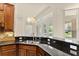 Kitchen counter area with stainless steel sink, granite countertop, and pendant lighting at 29152 David Ct, Tavares, FL 32778