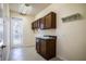 Laundry room with wooden cabinets, sink, and a door leading to outside at 29152 David Ct, Tavares, FL 32778