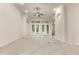 Expansive living room featuring neutral carpet, ample natural light, and access to the outdoors at 29152 David Ct, Tavares, FL 32778