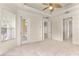 Spacious main bedroom with tray ceiling, fan, carpet, natural light, and access to the outdoors at 29152 David Ct, Tavares, FL 32778