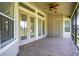 Spacious screened patio with tiled floors, ceiling fan, and multiple entry points at 29152 David Ct, Tavares, FL 32778