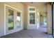 Covered patio with tiled floors and multiple doors leading inside at 29152 David Ct, Tavares, FL 32778