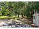 Expansive yard with mature trees, lush greenery, and a shed providing extra storage space at 29152 David Ct, Tavares, FL 32778