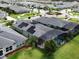 Aerial view of a neighborhood with screened-in pools, well-maintained lawns, and lush landscaping at 3021 King Palm Dr, New Smyrna Beach, FL 32168