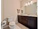 Bathroom with a modern vanity, marble countertop, decorative shelves, and a framed mirror at 3021 King Palm Dr, New Smyrna Beach, FL 32168