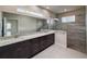 Modern bathroom featuring a double sink vanity with marble countertops and a luxurious walk-in shower at 3021 King Palm Dr, New Smyrna Beach, FL 32168