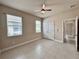 Bedroom with two windows, tile flooring and double doors to the closet at 3021 King Palm Dr, New Smyrna Beach, FL 32168