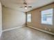 Bedroom with tile floor, ceiling fan, and two bright windows at 3021 King Palm Dr, New Smyrna Beach, FL 32168