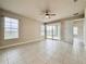 Bedroom with tile floors, ceiling fan, neutral paint and view of the backyard at 3021 King Palm Dr, New Smyrna Beach, FL 32168