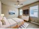 Tastefully decorated bedroom with modern furniture, tile flooring and two bright windows at 3021 King Palm Dr, New Smyrna Beach, FL 32168