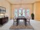 Formal dining room with chandelier, table, neutral paint, and sliding glass doors leading to patio at 3021 King Palm Dr, New Smyrna Beach, FL 32168