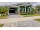 Charming home with a lovely front lawn, open garage, and well-maintained landscaping at 3021 King Palm Dr, New Smyrna Beach, FL 32168