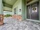 Welcoming front porch with a wreath on the front door and a neutral color palette, creating a cozy entry at 3021 King Palm Dr, New Smyrna Beach, FL 32168