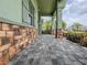 Charming front porch featuring stone accents and paver flooring, enhancing curb appeal and outdoor living space at 3021 King Palm Dr, New Smyrna Beach, FL 32168