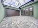 Garage with lots of paved space and natural lighting through the screened roof at 3021 King Palm Dr, New Smyrna Beach, FL 32168