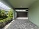 Spacious drive-through garage with a paved driveway and landscaped surroundings at 3021 King Palm Dr, New Smyrna Beach, FL 32168