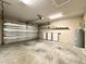 Spacious garage featuring Tesla powerwalls, water heater, and an automatic garage door at 3021 King Palm Dr, New Smyrna Beach, FL 32168