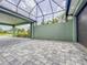 Large paved garage area with a partial view of the street through a screened roof at 3021 King Palm Dr, New Smyrna Beach, FL 32168