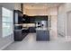 Kitchen featuring dark cabinetry, stainless steel appliances, an island, and a high ceiling at 3021 King Palm Dr, New Smyrna Beach, FL 32168