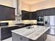 Spacious kitchen featuring a large island with a sink, stainless appliances and a modern design at 3021 King Palm Dr, New Smyrna Beach, FL 32168