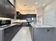 Modern kitchen featuring dark cabinets, stainless steel appliances and a large center island at 3021 King Palm Dr, New Smyrna Beach, FL 32168