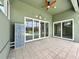 View of the lanai with blue tiled mini-fridge, ceiling fan, tile floor, and sliding glass doors to the pool area at 3021 King Palm Dr, New Smyrna Beach, FL 32168