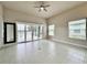 Open floor plan living room with tile floors, neutral paint, ceiling fan and exterior views at 3021 King Palm Dr, New Smyrna Beach, FL 32168
