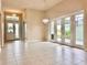 Bright living space with tile flooring, neutral tones and high ceilings with double doors to the patio at 3021 King Palm Dr, New Smyrna Beach, FL 32168