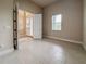 Bright and open living space with tile flooring and views to foyer with natural light at 3021 King Palm Dr, New Smyrna Beach, FL 32168