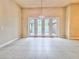 Spacious living space with tile flooring, natural light, and an open layout, ideal for entertaining at 3021 King Palm Dr, New Smyrna Beach, FL 32168