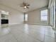 Unfurnished main bedroom with tile floors, neutral paint, ceiling fan, and exterior views at 3021 King Palm Dr, New Smyrna Beach, FL 32168