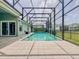 Refreshing screened pool with a patio creates a perfect space to unwind and enjoy the outdoors at 3021 King Palm Dr, New Smyrna Beach, FL 32168