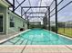 Inviting screened pool featuring a spa offers a private oasis for relaxation and recreation in your backyard at 3021 King Palm Dr, New Smyrna Beach, FL 32168