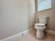 Clean and simple bathroom featuring a standard toilet, neutral walls, and tiled floor at 3021 King Palm Dr, New Smyrna Beach, FL 32168