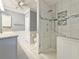 Bathroom with a modern shower, marble tiling, and classic vanity at 3237 Atwell Ave, The Villages, FL 32162