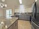 Stylish kitchen with granite counters, stainless steel appliances, and ample cabinet space at 3237 Atwell Ave, The Villages, FL 32162