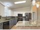 Modern kitchen featuring granite counters, stainless steel appliances and elegant pendant lighting at 3237 Atwell Ave, The Villages, FL 32162