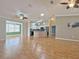 Spacious living area with hardwood floors leading to the kitchen and bright sunroom at 3237 Atwell Ave, The Villages, FL 32162
