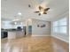 Open-concept living room showcases hardwood floors and seamless flow into the modern kitchen at 3237 Atwell Ave, The Villages, FL 32162