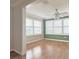 Cozy sunroom filled with natural light from multiple windows and featuring hardwood floors at 3237 Atwell Ave, The Villages, FL 32162