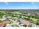 Panoramic aerial view of a home with a nearby lake and verdant golf course in the distance at 3331 Overland Ter, The Villages, FL 32163