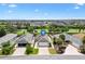 Aerial view of a home with a well-manicured lawn, mature trees, and a driveway at 3331 Overland Ter, The Villages, FL 32163