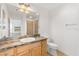 Bathroom featuring a vanity with marbled countertop, a sink, and a toilet with a shower in the background at 3331 Overland Ter, The Villages, FL 32163