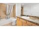 Bathroom with tub and shower combination, neutral tile, and a vanity with marble countertop at 3331 Overland Ter, The Villages, FL 32163