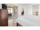 Bedroom with sliding door access to the screened patio, wood floors, and neutral color scheme at 3331 Overland Ter, The Villages, FL 32163