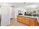 Open-concept kitchen and dining area with tiled floors and ample natural light at 3331 Overland Ter, The Villages, FL 32163